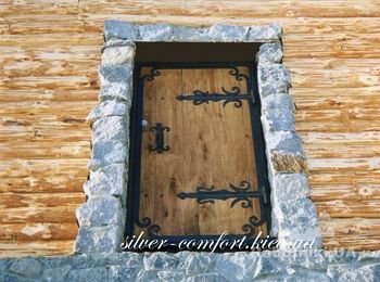 Деревянная дверь с кованными накладками